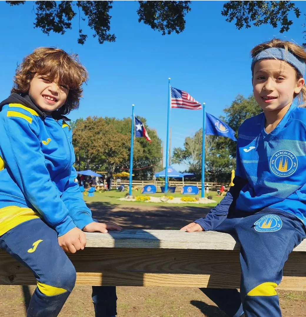 Two young players sitting on a bench at the campus