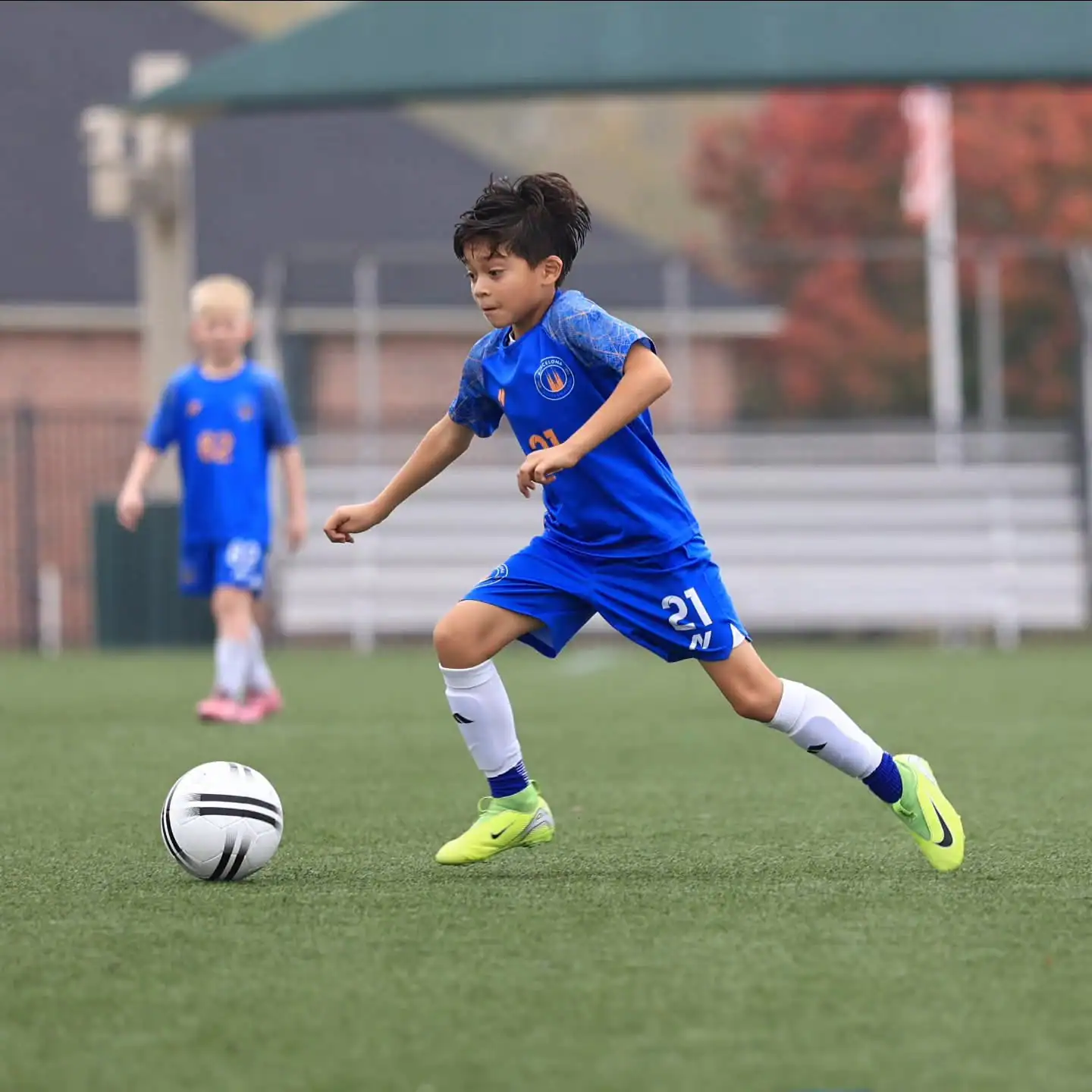 Young Barcelona Soccer Excellence player dribbling a ball on the training pitch